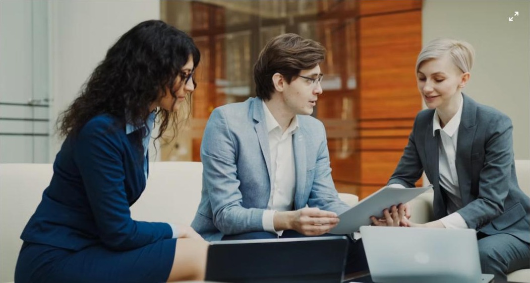 Professionals reviewing data on a tablet - UAE Competition Framework 2026