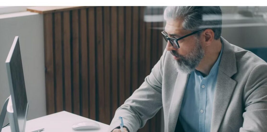 Professional working at desk on a laptop - UAE eInvoicing 2026