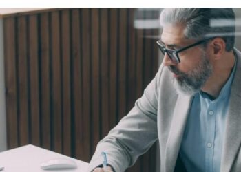Professional working at desk on a laptop - UAE eInvoicing 2026
