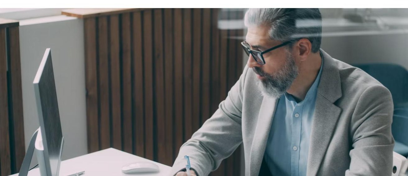 Professional working at desk on a laptop - UAE eInvoicing 2026