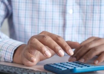 Small business owner using a calculator - UAE Small Business Relief 2029