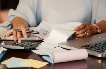 Accountant reviewing VAT documents with a calculator